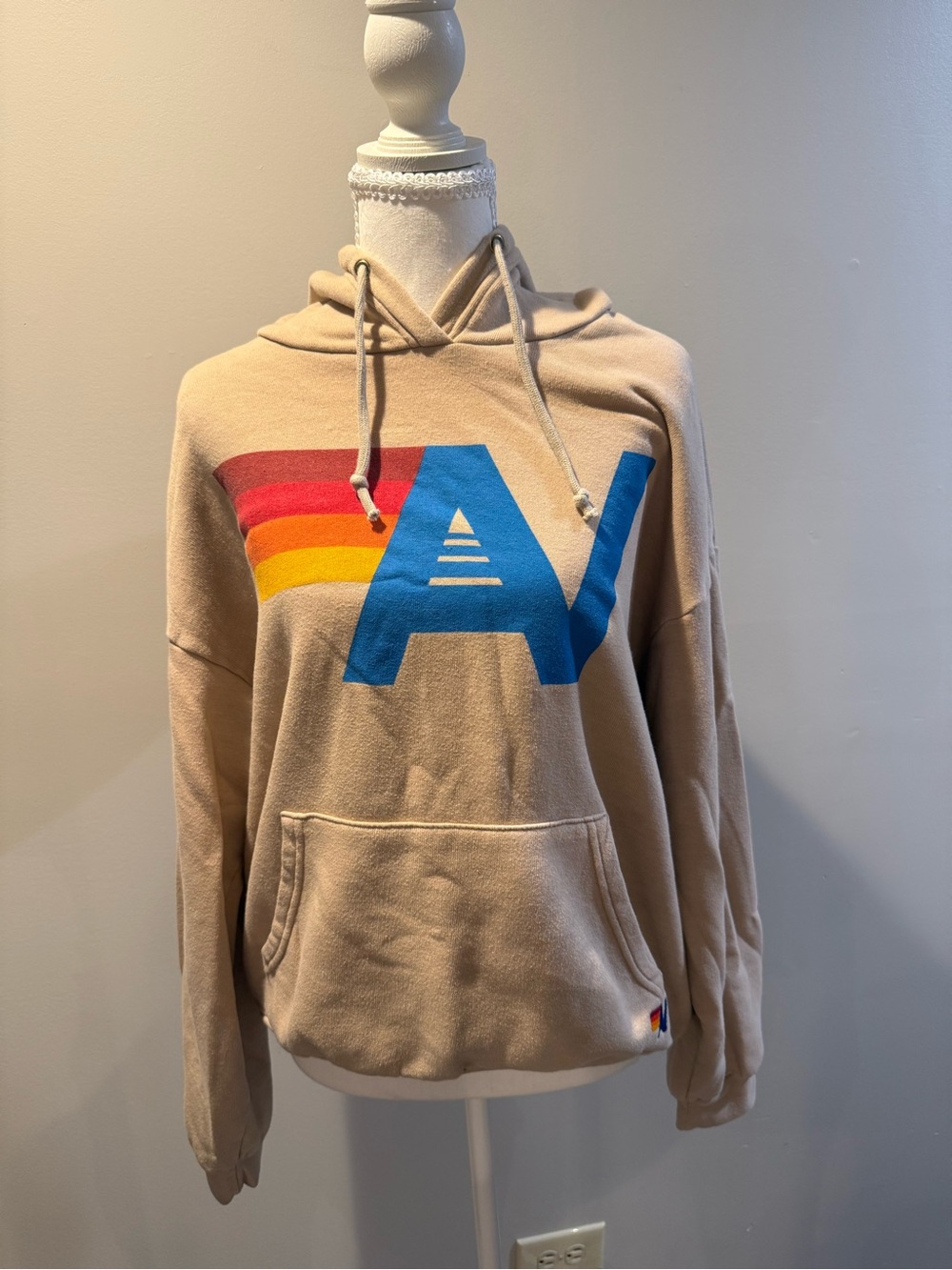 Aviator Nation Beige Hoodie with Blue 'A' and Red-Orange-Yellow Stripe